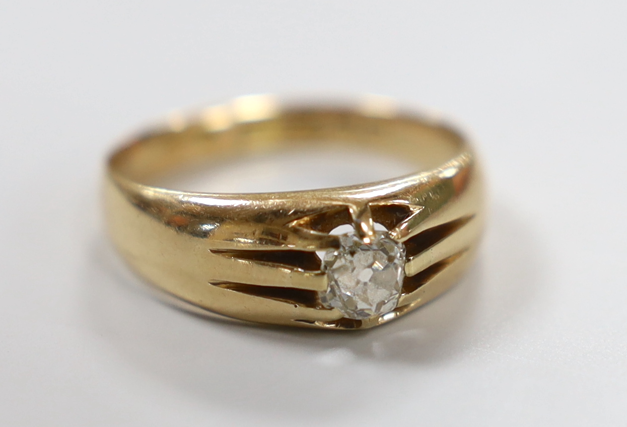 A late Victorian 15ct gold and claw set solitaire diamond ring, size Q, gross weight 5.5 grams.